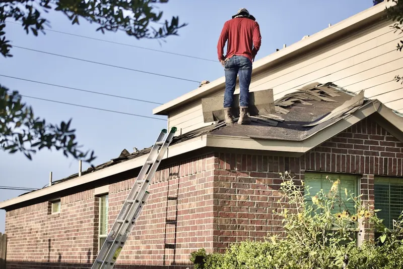 Professional roofer working on a residential roof in East Chicago